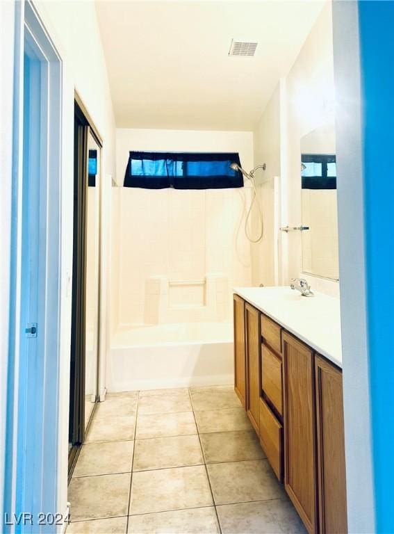 bathroom featuring tile patterned floors, vanity, and shower / bathtub combination