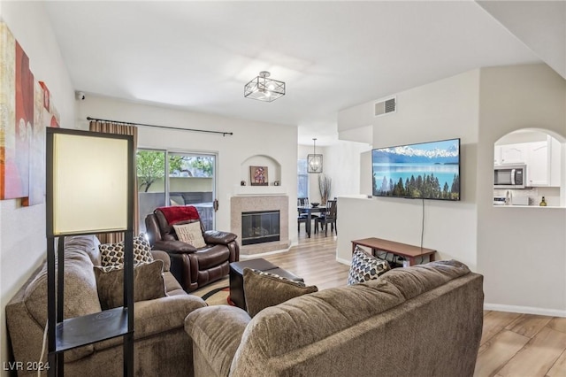 living room featuring light hardwood / wood-style floors and a chandelier