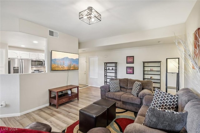 living room with light hardwood / wood-style flooring