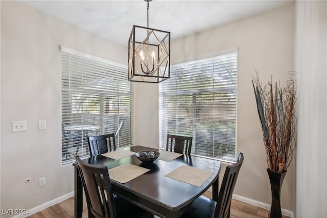 dining area featuring a notable chandelier and light hardwood / wood-style flooring