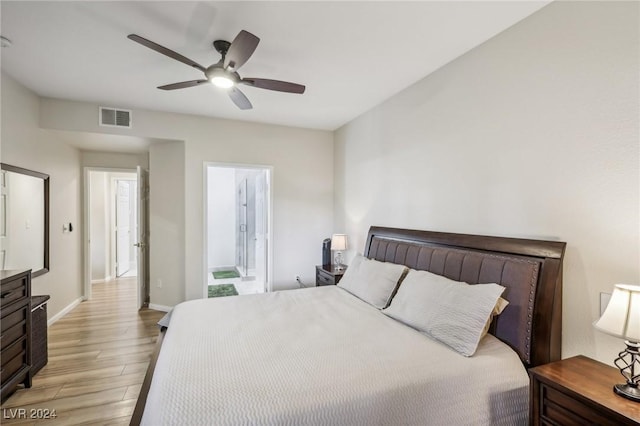 bedroom with ensuite bath, ceiling fan, and light hardwood / wood-style flooring