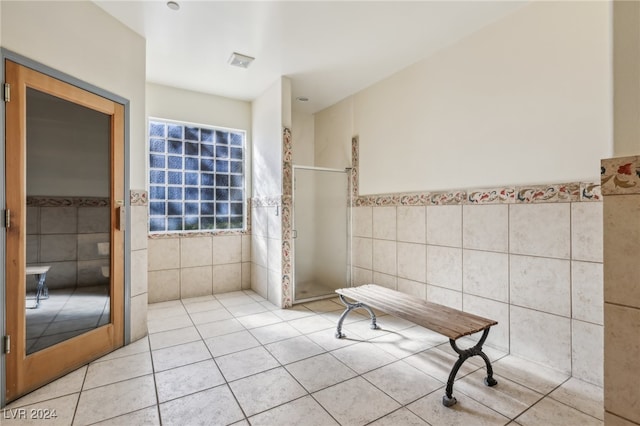 bathroom with tile walls and tile patterned flooring