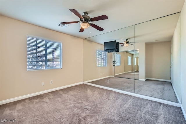 unfurnished bedroom featuring carpet flooring and ceiling fan