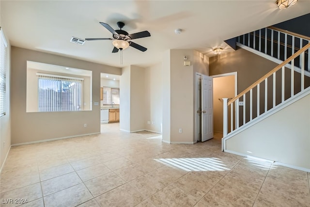 unfurnished room with ceiling fan and light tile patterned floors