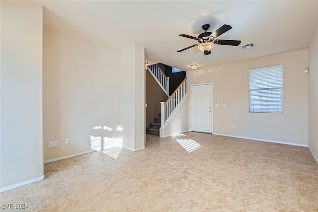 unfurnished living room with ceiling fan