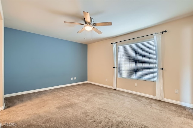 empty room with ceiling fan and carpet