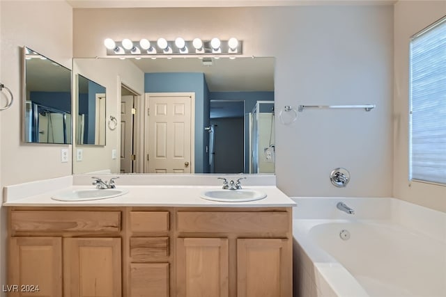 bathroom with vanity and separate shower and tub