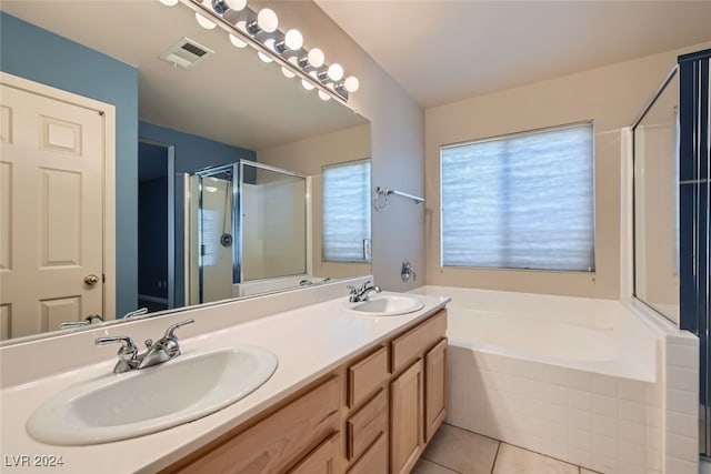 bathroom featuring tile patterned flooring, vanity, a wealth of natural light, and independent shower and bath