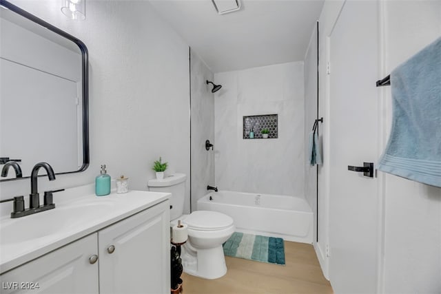 full bathroom with vanity, wood-type flooring, tiled shower / bath combo, and toilet