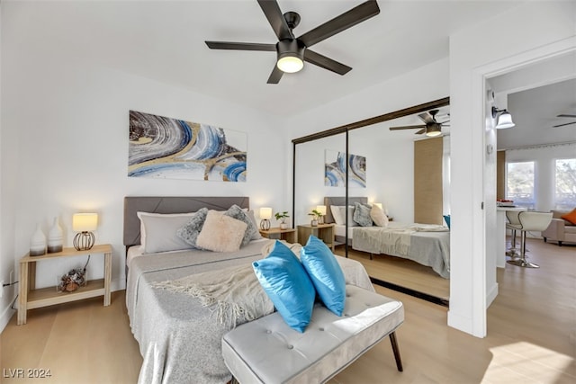 bedroom featuring ceiling fan, a closet, and light wood-type flooring