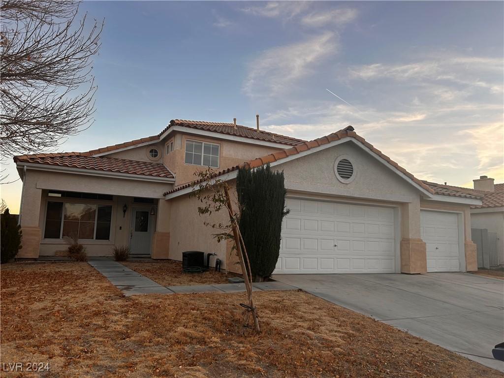 mediterranean / spanish-style home featuring a garage