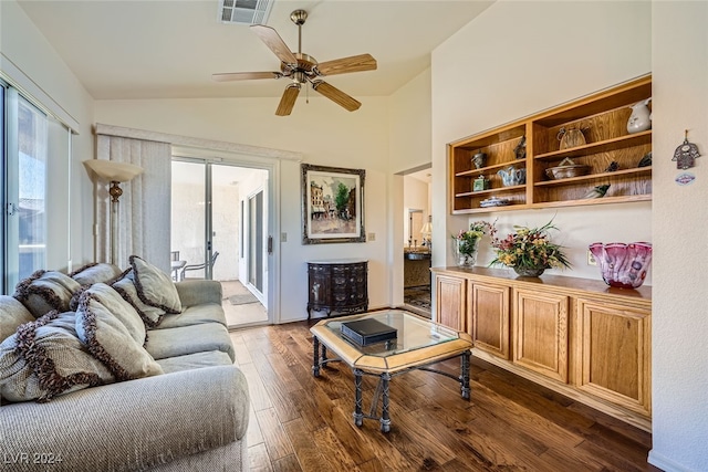 living room with ceiling fan, dark wood-type flooring, and vaulted ceiling