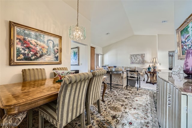 carpeted dining space with vaulted ceiling and a notable chandelier