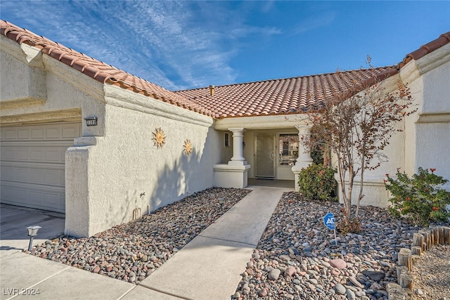 doorway to property with a garage