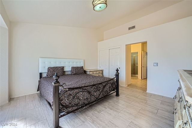 bedroom with light hardwood / wood-style floors and a closet