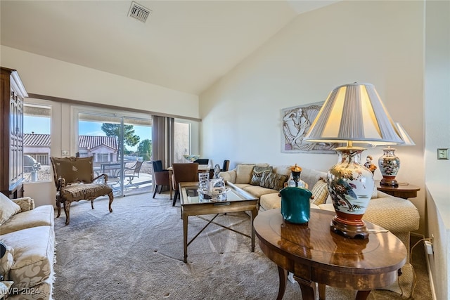 living room featuring carpet floors and lofted ceiling