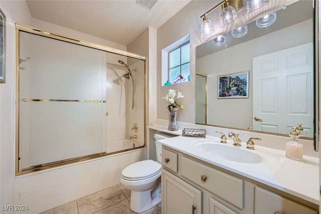 full bathroom with tile patterned flooring, vanity, toilet, and enclosed tub / shower combo