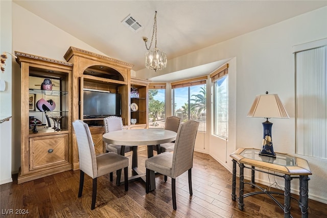 dining room with dark hardwood / wood-style floors, vaulted ceiling, and a notable chandelier