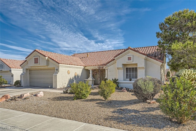 mediterranean / spanish-style house with a garage