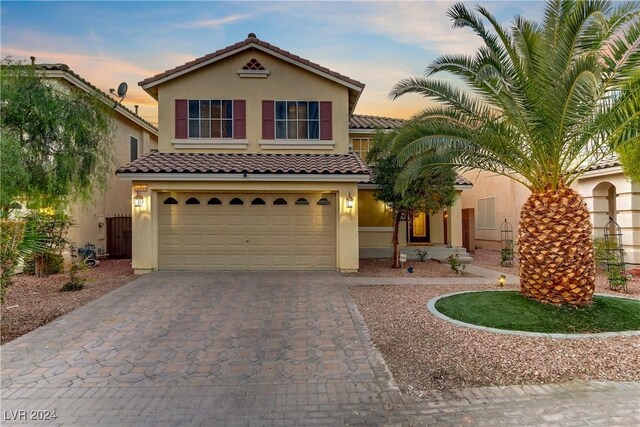 mediterranean / spanish house with a garage