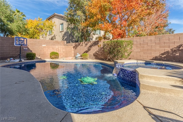 view of pool with an in ground hot tub and pool water feature