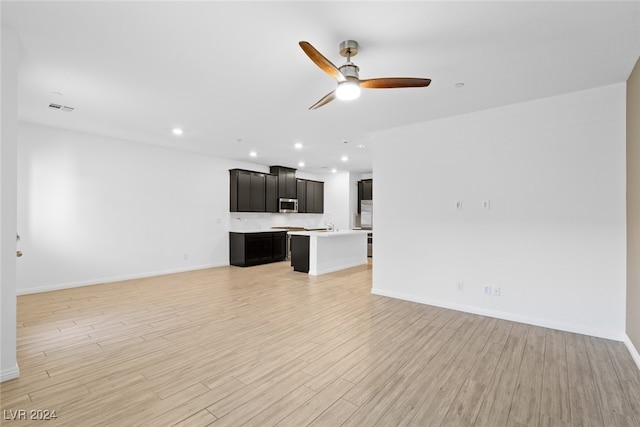 unfurnished living room featuring light wood-type flooring and ceiling fan