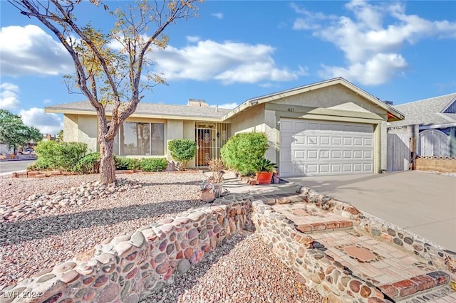 single story home with an attached garage, driveway, and stucco siding