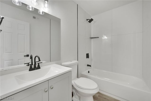 full bathroom with toilet, tub / shower combination, hardwood / wood-style floors, and vanity