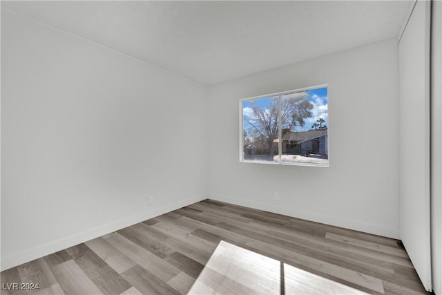 unfurnished room with light wood-type flooring