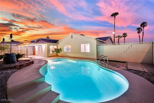 view of pool at dusk