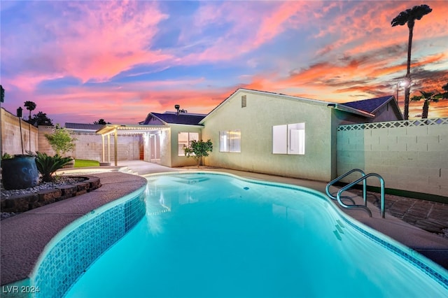 view of pool at dusk