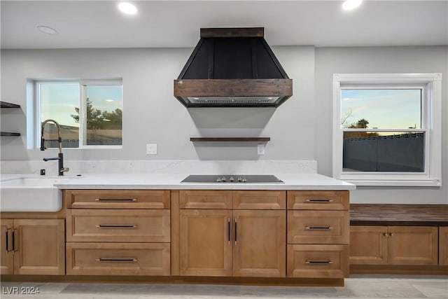 kitchen with a sink, open shelves, exhaust hood, black electric stovetop, and recessed lighting