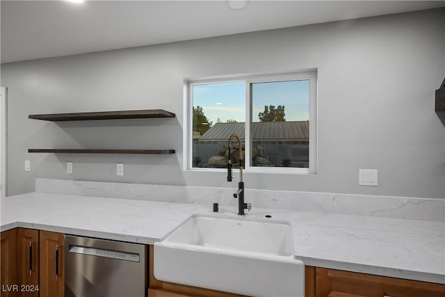 kitchen with a sink, open shelves, brown cabinetry, light stone countertops, and dishwasher