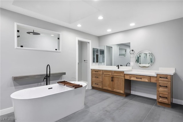 full bathroom featuring baseboards, a freestanding tub, tile patterned flooring, vanity, and recessed lighting