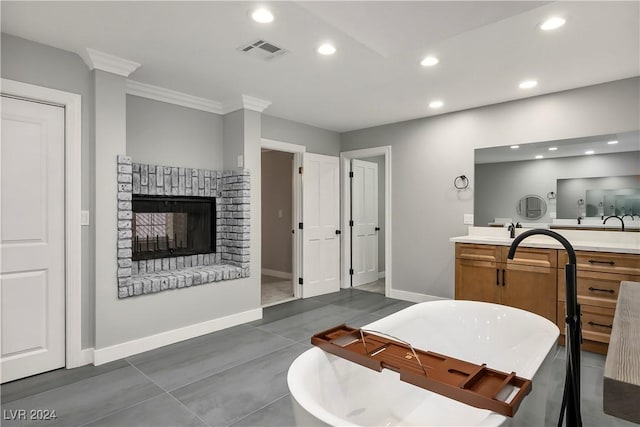 interior space featuring a freestanding bath, visible vents, ornamental molding, and recessed lighting