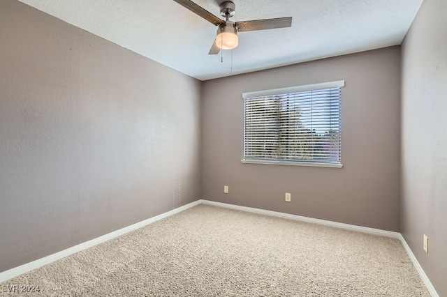 carpeted empty room featuring ceiling fan