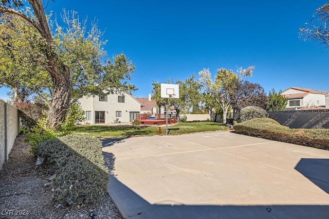 view of basketball court featuring a yard