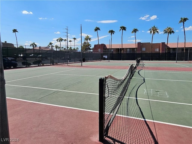 view of tennis court with basketball hoop