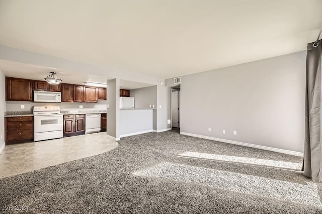 kitchen featuring carpet flooring and white appliances