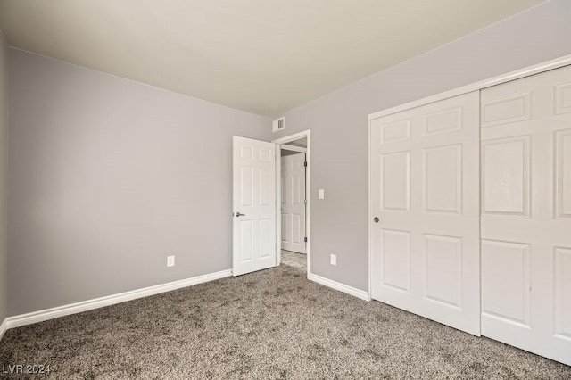 unfurnished bedroom featuring a closet and carpet floors