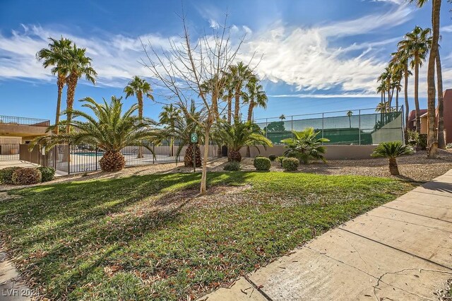 view of home's community featuring a yard and a swimming pool