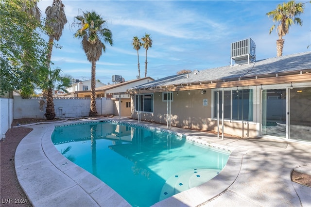 view of pool featuring cooling unit and a patio