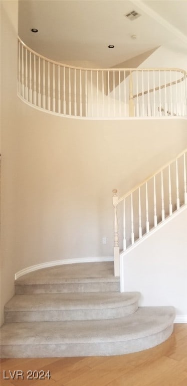 stairs featuring hardwood / wood-style flooring