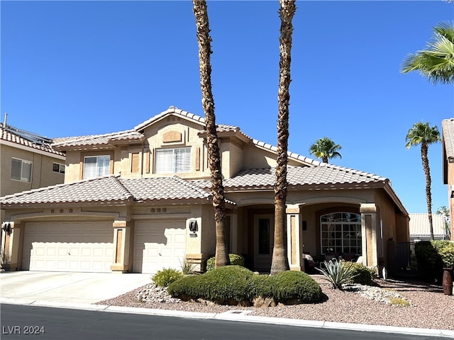 mediterranean / spanish-style home with a garage