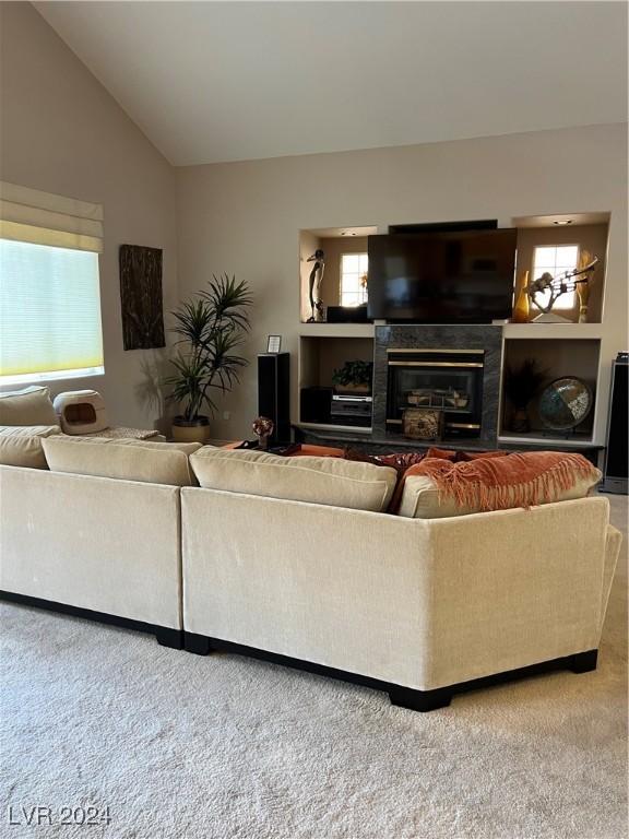 carpeted living room featuring lofted ceiling