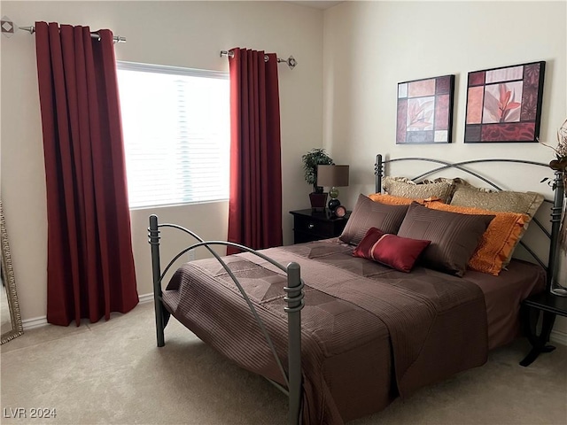 bedroom featuring light colored carpet