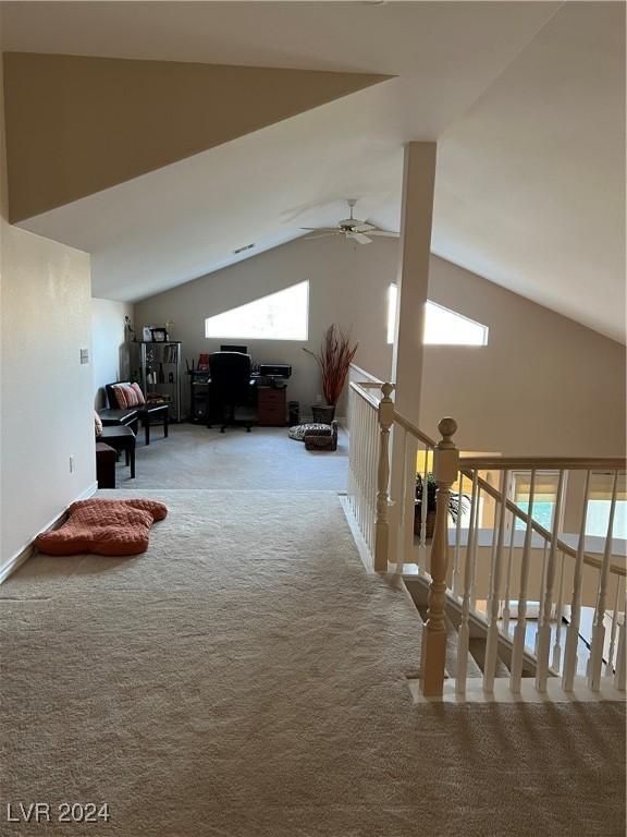 bonus room with ceiling fan, plenty of natural light, carpet floors, and high vaulted ceiling