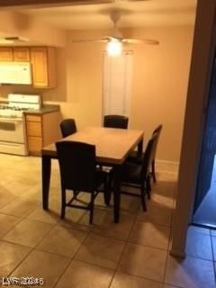 dining space featuring ceiling fan and light tile patterned flooring