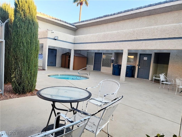 view of patio / terrace featuring a shed and a pool