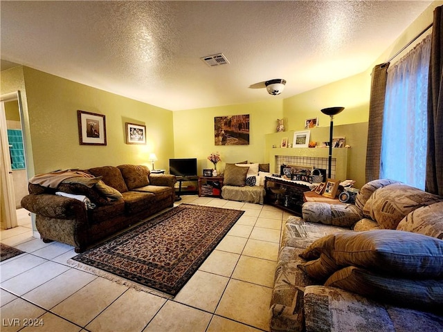 living room featuring light tile patterned floors and a textured ceiling